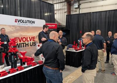 Visitors talking with the Evolution team at the LHOS 2026 booth
