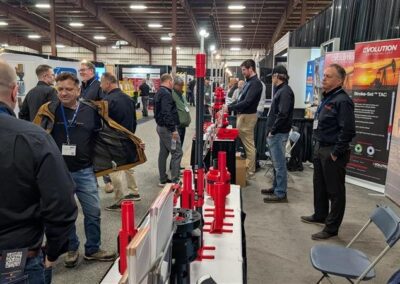 Attendees on the LHOS 2026 trade show floor near the Evolution booth